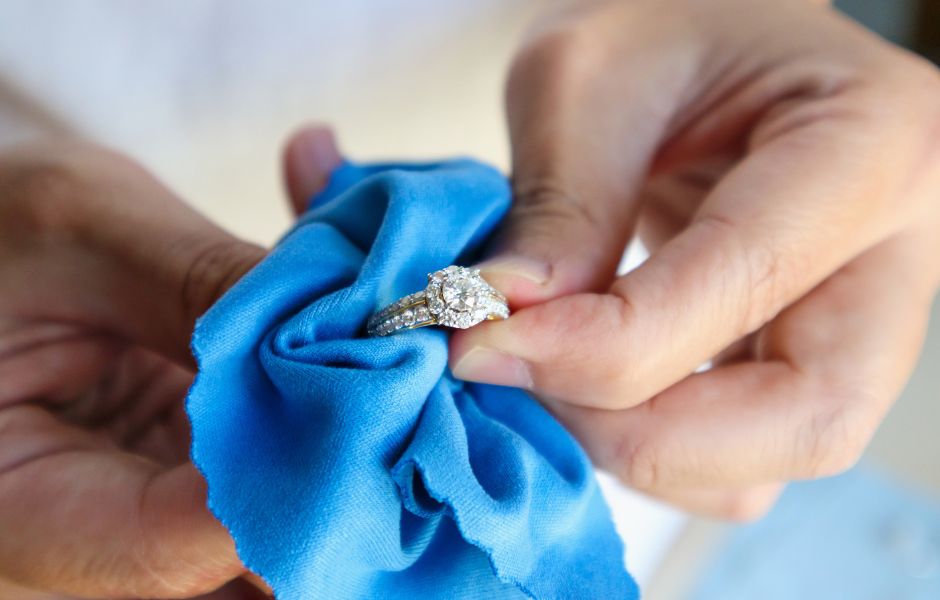 hands holding a ring - jewelers block coverage